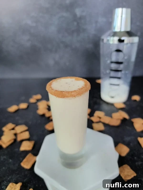 Sweet Cinnamon Crunch Shooter 8 Cinnamon toast crunch shot on marble coasters with a cocktail shaker in the background