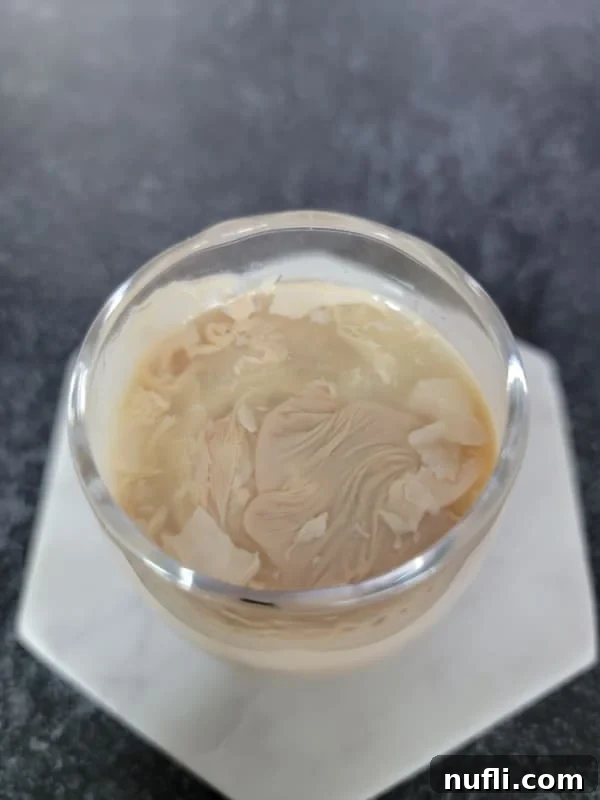 Looking down into a cement mixer shot to see the irish cream and lime juice curdling