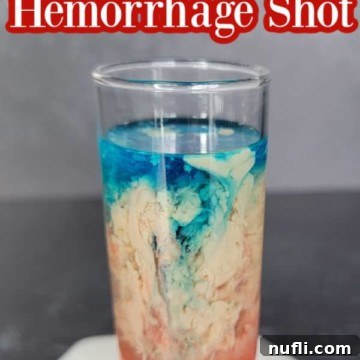 Alien Brain Hemorrhage Shot text over a red, cream, and blue cocktail shot on a coaster