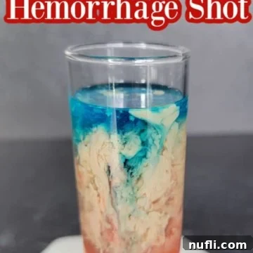 Alien Brain Hemorrhage Shot How To 9 Alien Brain Hemorrhage Shot text over a red, cream, and blue cocktail shot on a coaster