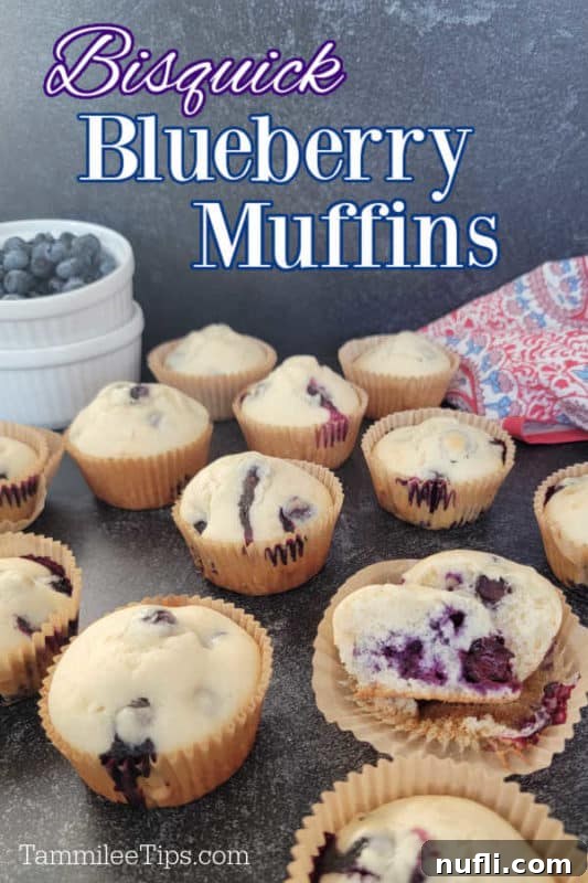 Bisquick Blueberry Muffins on a wooden board with fresh blueberries in a glass bowl