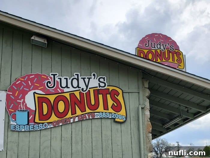 Judy's Donuts sign on the side of a green building