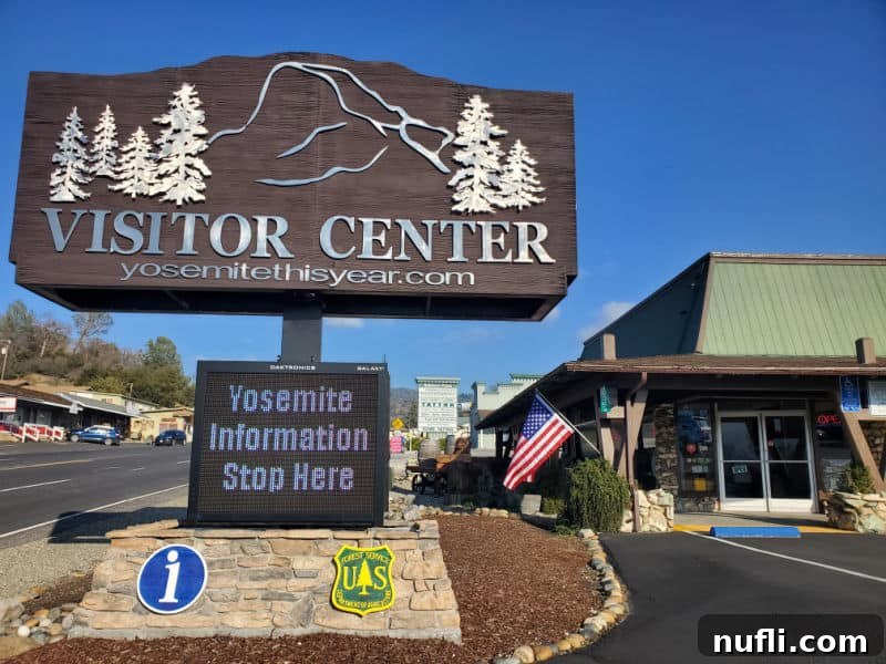 Visitor center sign with half dome and Yosemite information stop here