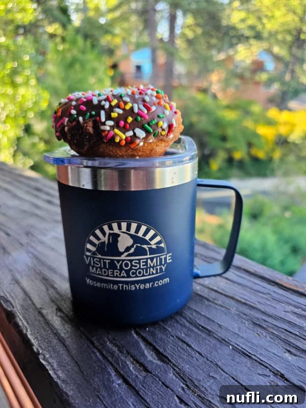 rainbow sprinkle covered donut on a blue Yosemite Madera County coffee mug