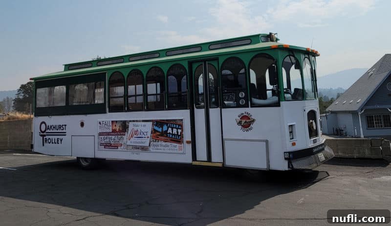 Oakhurst Trolley with a green roof and artober sign
