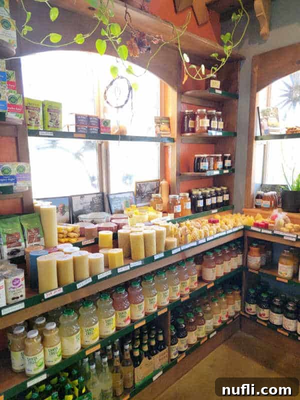 Unlocking North Fork California 11 Candles, honey, and juice on display in The Gnarly Carrot, showcasing local organic products.