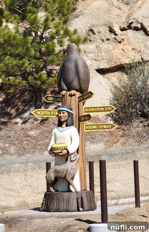 Unlocking North Fork California 15 Sculpture with an eagle, First Nations female holding a basket, fox, and signs to places in North Fork, symbolizing local culture and wildlife.
