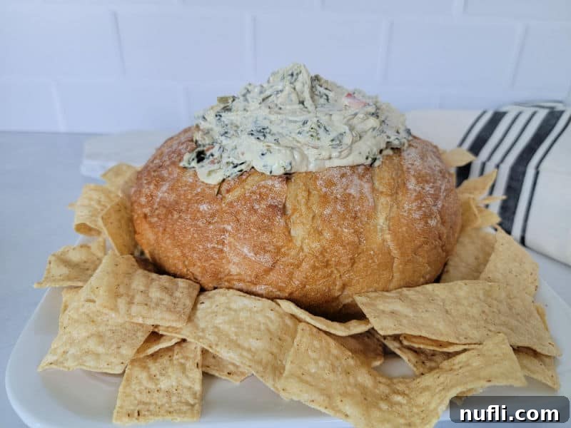 Knorr Spinach Dip Effortless Entertaining 6 Knorr Spinach Dip in a bread bowl, surrounded by tortilla chips, ready to be enjoyed as a festive appetizer.