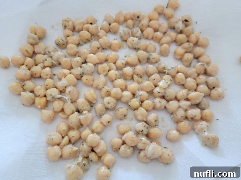 Seasoned chickpeas spread on a paper towel for air drying