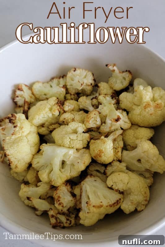 A white bowl brimming with perfectly air-fried cauliflower florets, showcasing their golden-brown edges and inviting texture.