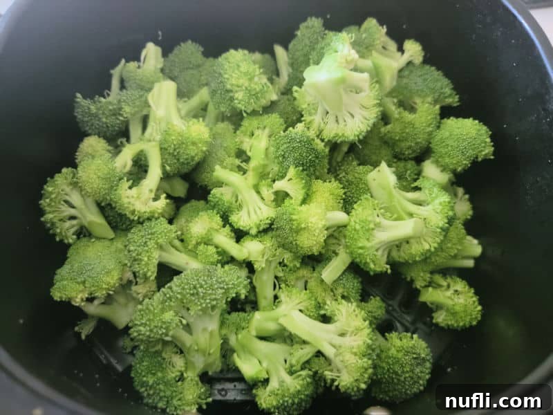 Broccoli in an air fryer basket