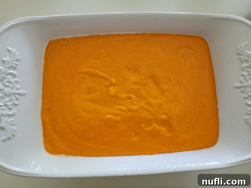 Easy Fluffy Carrot Soufflé 6 Unbaked carrot soufflé mixture poured into a greased casserole dish, ready to be transferred to the oven