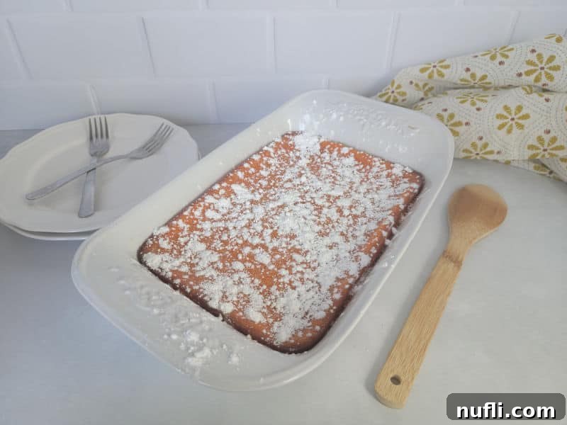 Easy Fluffy Carrot Soufflé 8 Beautifully garnished carrot soufflé in a casserole dish, dusted with powdered sugar, ready to be served at a family gathering
