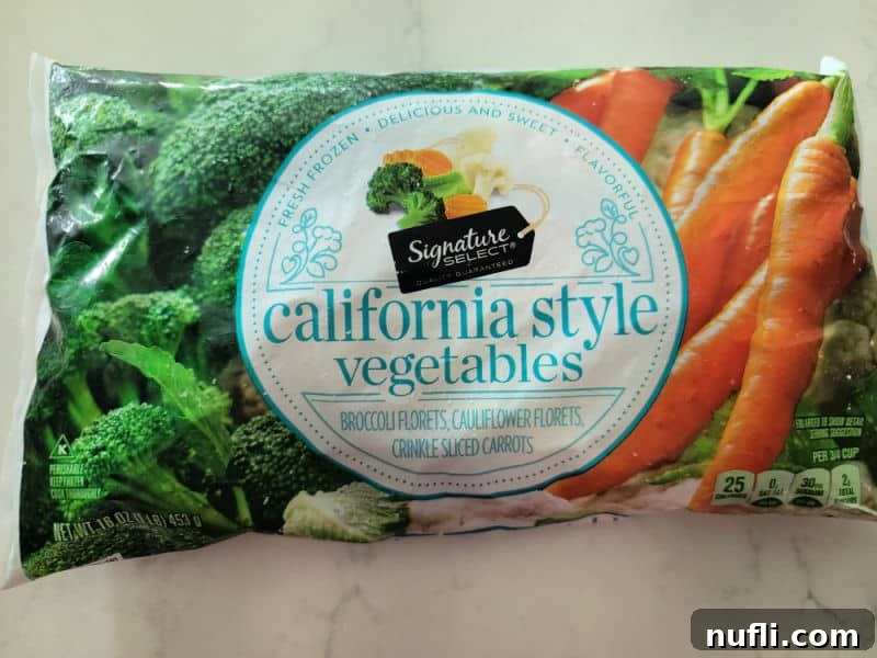 A bag of California Style frozen mixed vegetables, showing broccoli, cauliflower, and carrots.