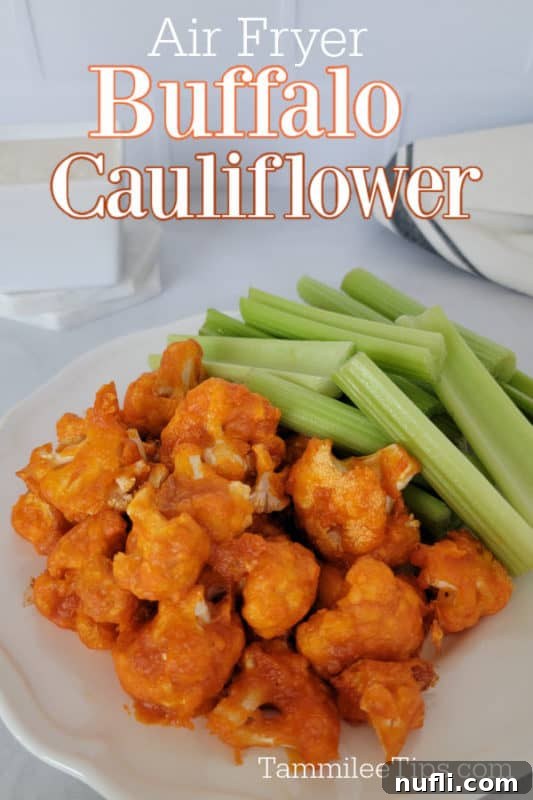 Air fryer buffalo cauliflower over a white plate with buffalo cauliflower and celery sticks