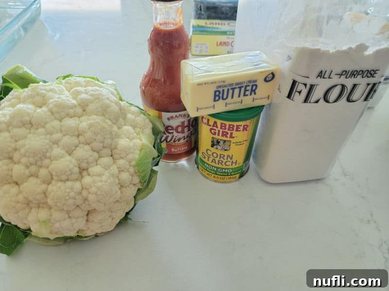 cauliflower, buffalo sauce, butter, corn starch, and flour on a white counter