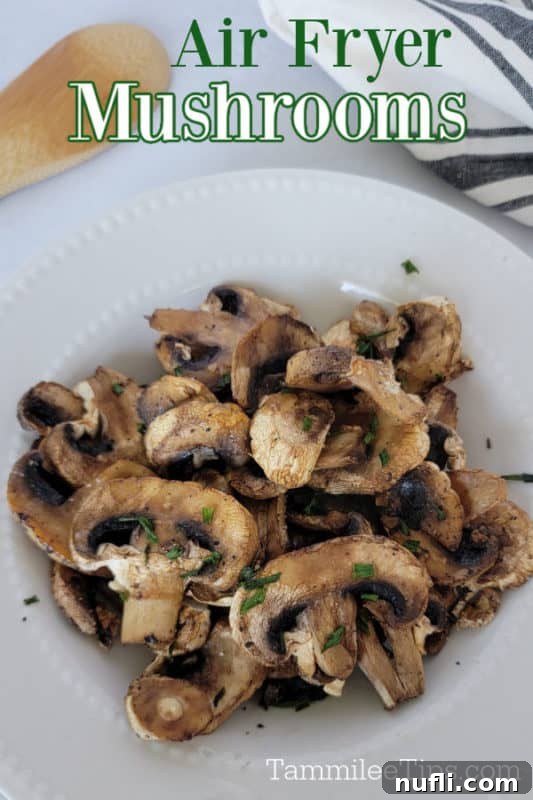 Air fryer mushrooms over a white plate with air fried mushrooms and a wooden spoon