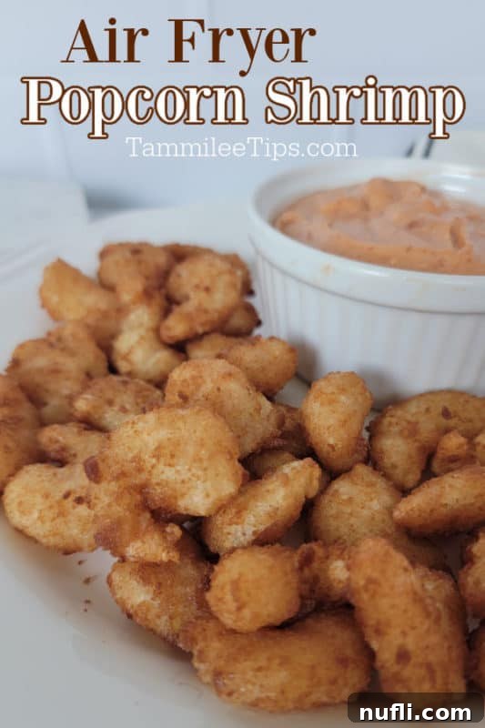 Crispy Air Fryer Frozen Popcorn Shrimp 2 Air fryer popcorn shrimp over a plate of shrimp with a bowl of sauce, ready to be served