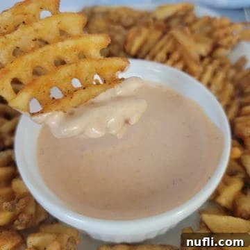 waffle fry dipping into a bowl of Comeback Sauce