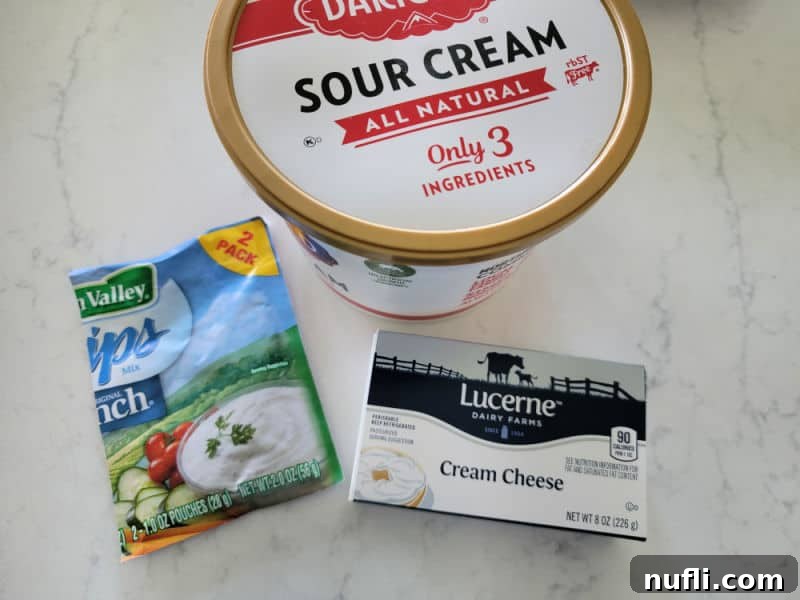 Simple 3-Ingredient Creamy Hidden Valley Ranch Dip 3 Sour cream, ranch dip and cream cheese on a white counter