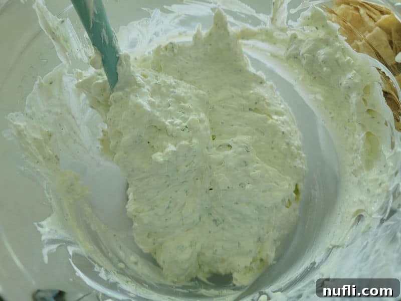 Simple 3-Ingredient Creamy Hidden Valley Ranch Dip 6 Spatula stirring ranch dip in a glass bowl