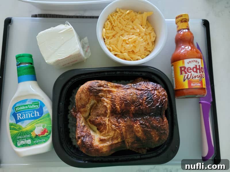 Buffalo Chicken Dip ingredients, ranch dressing, rotisserie chicken, cream cheese, shredded cheddar cheese, Frank's RedHot Buffalo Wing Sauce. 