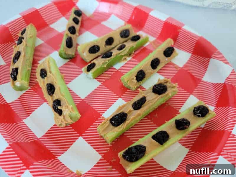 Ants on a log celery sticks on a red and white gingham print plate