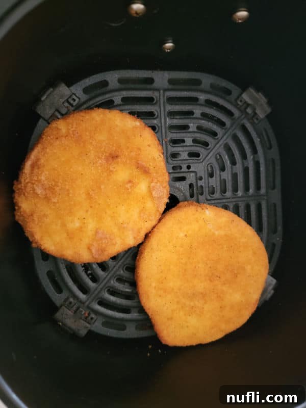 air fried chicken patties in an air fryer basket