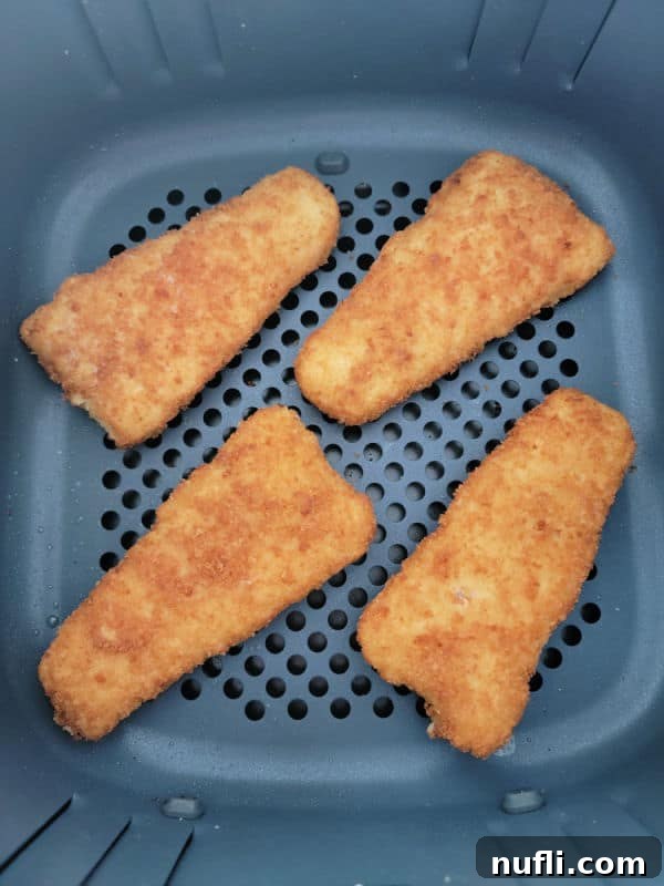 frozen fish fillets in an air fryer basket