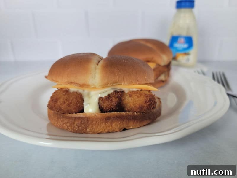 two air fried fish fillet sandwiches on a white plate