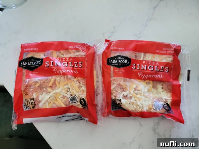 Packages of Sabatasso frozen pepperoni pizza singles