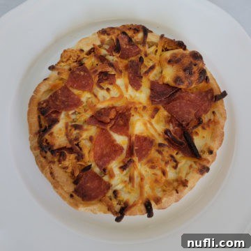air fried pepperoni pizza on a white plate