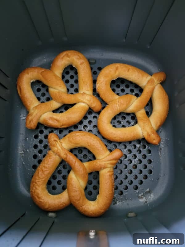 Cooked frozen pretzels in an air fryer basket