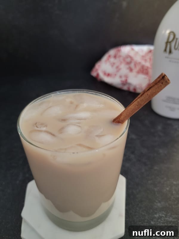 Creamy RumChata Iced Coffee Bliss 3 RumChata Iced Coffee in a clear glass with a bottle of RumChata