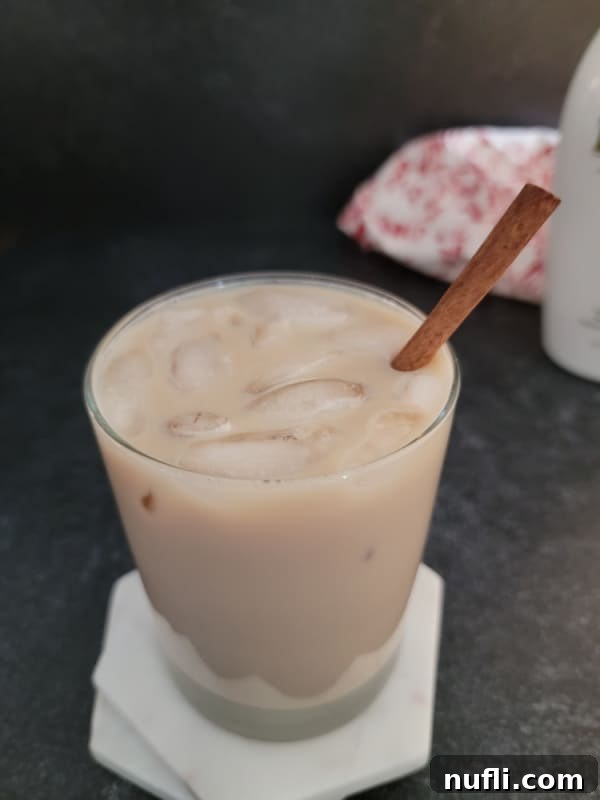 Creamy RumChata Iced Coffee Bliss 4 Iced RumChata Coffee with a cinnamon stick in a clear glass