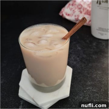 Creamy RumChata Iced Coffee Bliss 6 RumChata Iced Coffee with a cinnamon stick garnish on white coasters