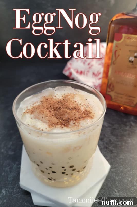 Simple Amaretto Eggnog Cocktail 6 A beautifully composed Amaretto Eggnog cocktail in a glass, with 'Eggnog Cocktail' text creatively overlaid, highlighting the drink's appeal.