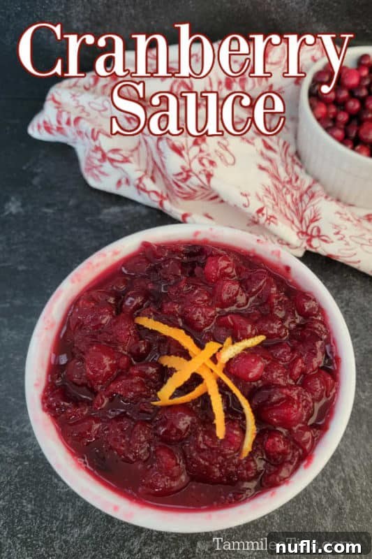 Cranberry Sauce text printed over a white bowl filled with the best cranberry sauce recipe next to a red and white cloth 