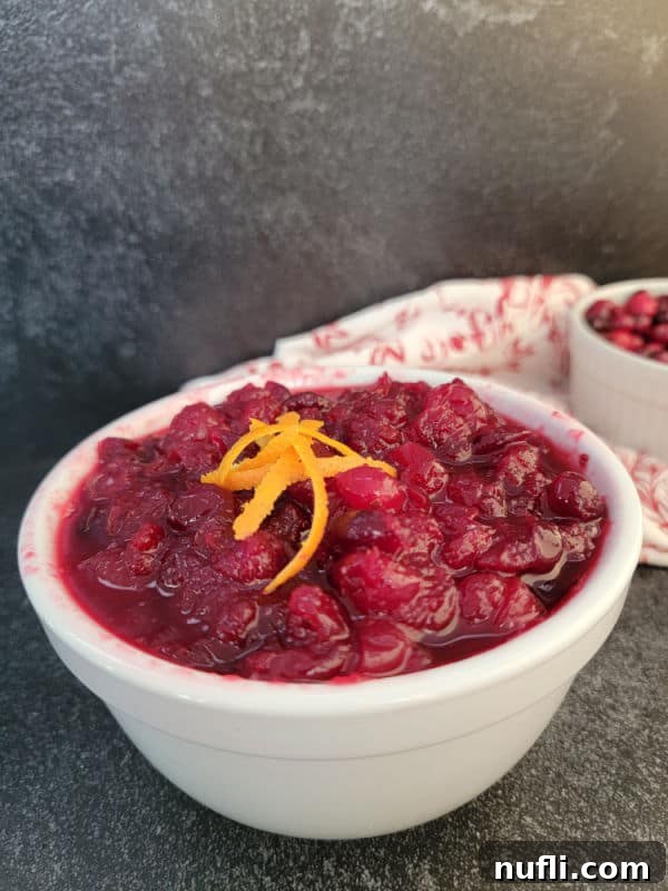 Cranberry sauce in a white bowl with orange zest
