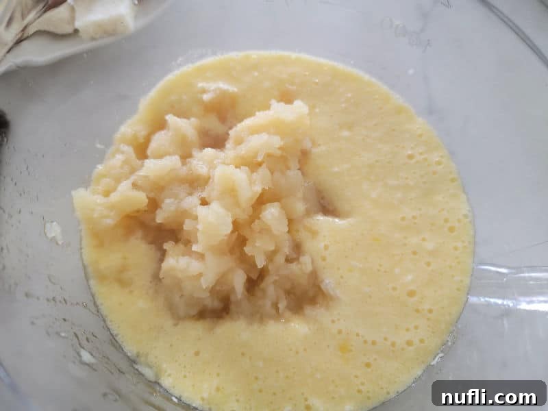 Effortless 5 Ingredient Pineapple Stuffing 6 crushed pineapple in butter mixture in a glass bowl for pineapple stuffing