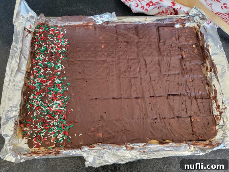 Irresistible 4 Ingredient Christmas Crack 11 Christmas Crack Saltine Toffee Candy on an aluminum foil lined baking sheet