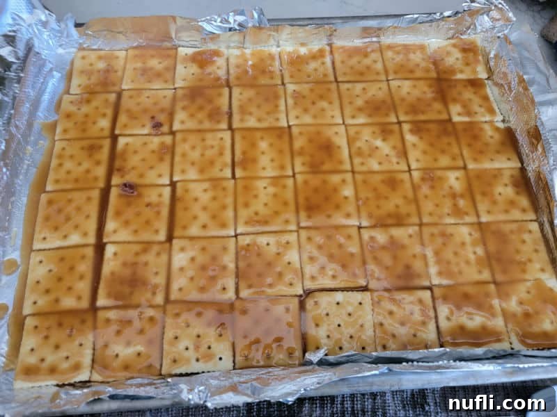 Irresistible 4 Ingredient Christmas Crack 8 Toffee mixture spread over Saltines to make Christmas Crack