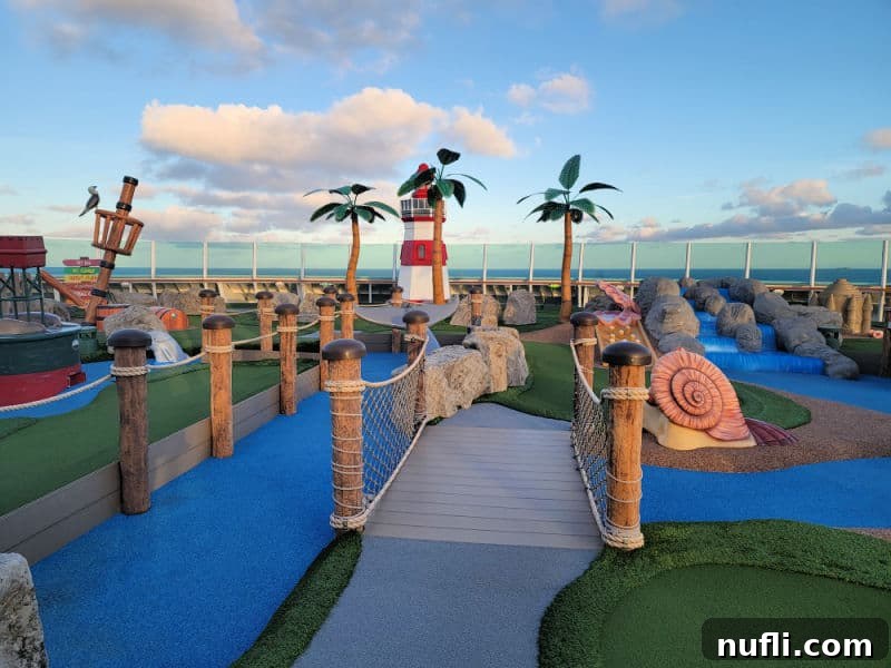 Putt Putt golf with a lighthouse, fake palm trees and a view of the ocean. 