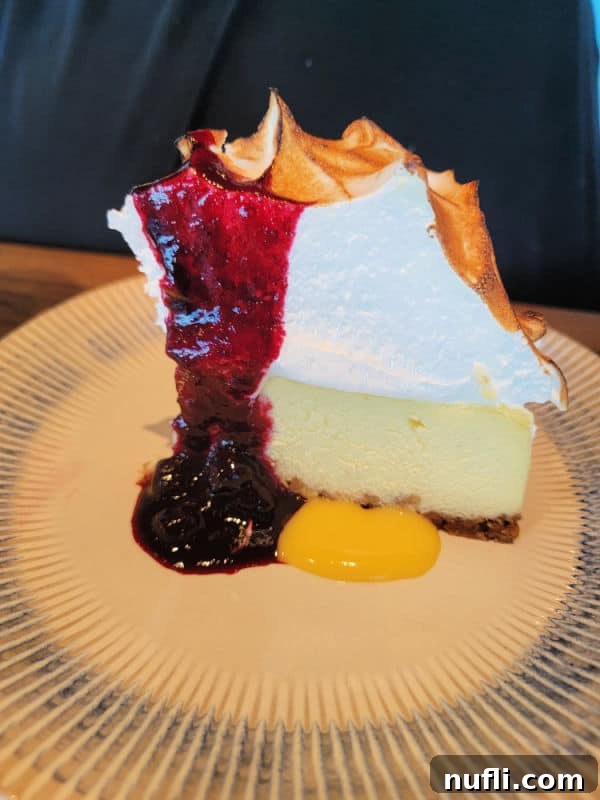 Key lime pie with meringue and a fruit sauce
