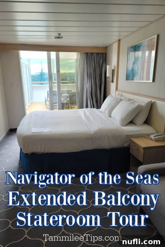 Navigator of the Seas Extended Balcony Stateroom Tour: A cozy bed next to a sliding glass door leading to a spacious balcony, offering panoramic sea views.