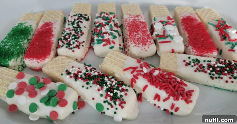 White chocolate dipped wafer cookies coated in vibrant holiday sprinkles, ready to be enjoyed