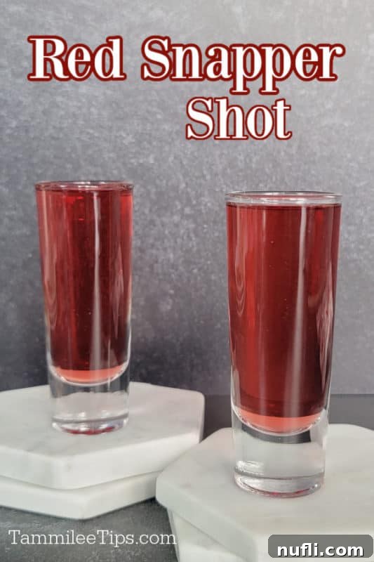 Crimson Capture 2 Red Snapper Shot text over two shot glasses with red liquid in them sitting on two white coasters.