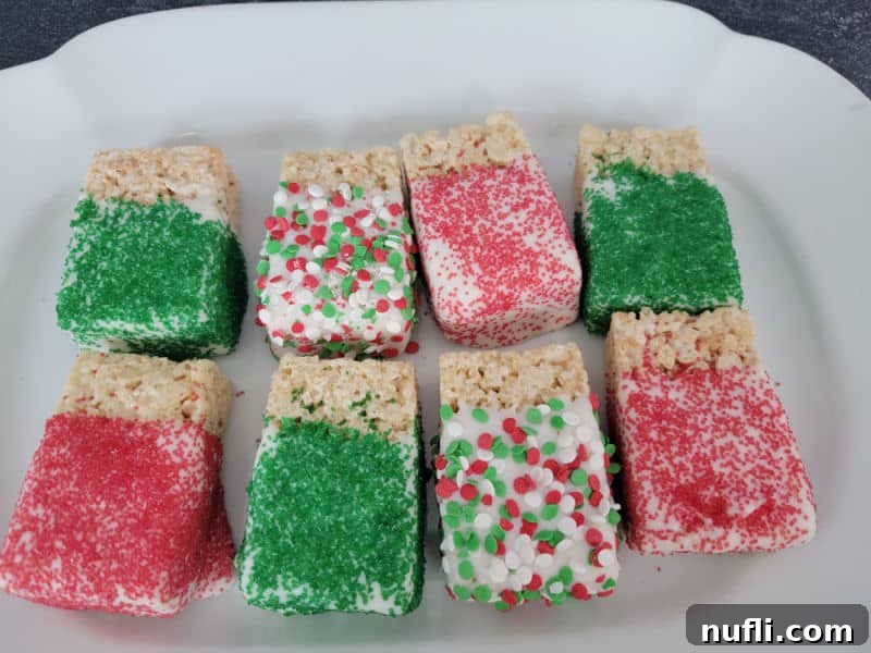 Crispy Chocolate Dream Bites 7 Chocolate covered rice krispie treats covered in holiday sprinkles on a white platter