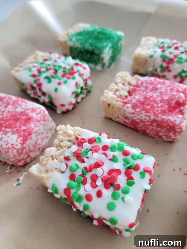 Crispy Chocolate Dream Bites 8 Chocolate covered rice krispie treats covered in holiday sprinkles on parchment paper