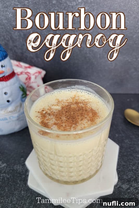 Bourbon Eggnog text written over a crystal glass filled with bourbon eggnog cocktail topped with ground nutmeg